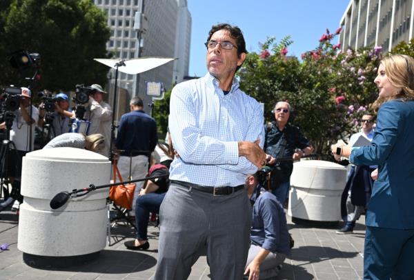 Mark Chavez, the ketamine doctor, standing outside Roybal Federal Courthouse with his arms crossed after court appearance.